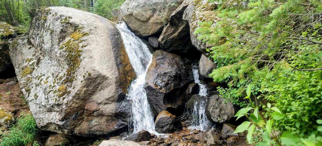 Scenic view of Green Mountain Falls with water running over rocks.