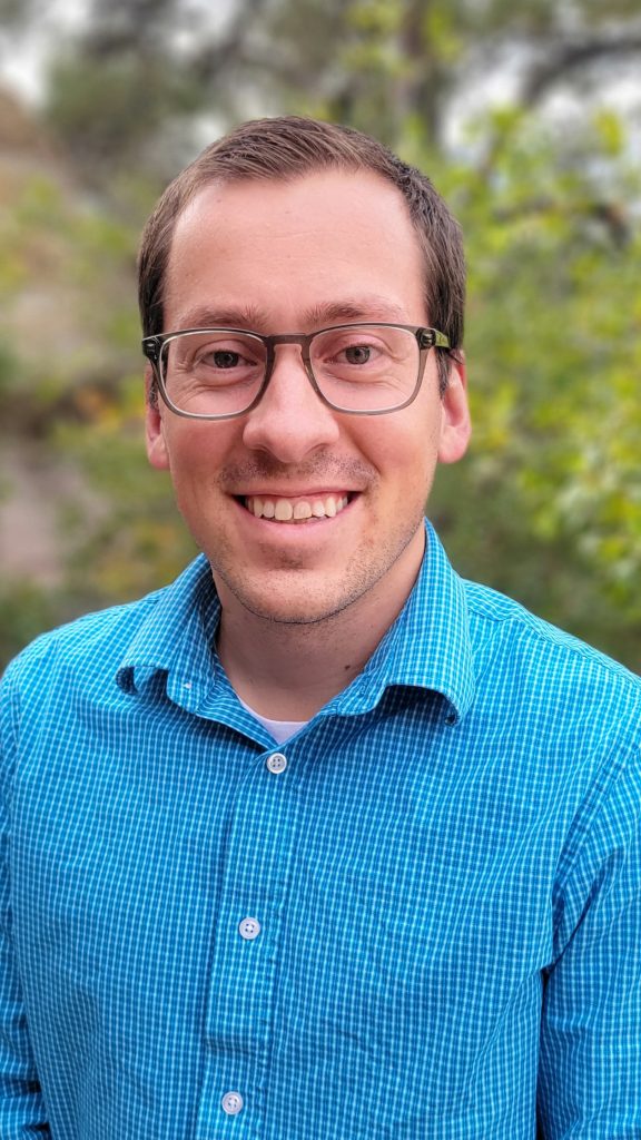 Headshot of Adam Noel outside.